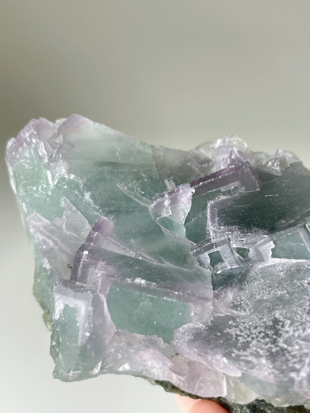 Beautiful fluorite crystal specimen showcasing vibrant green and purple hues, with intricate formations.