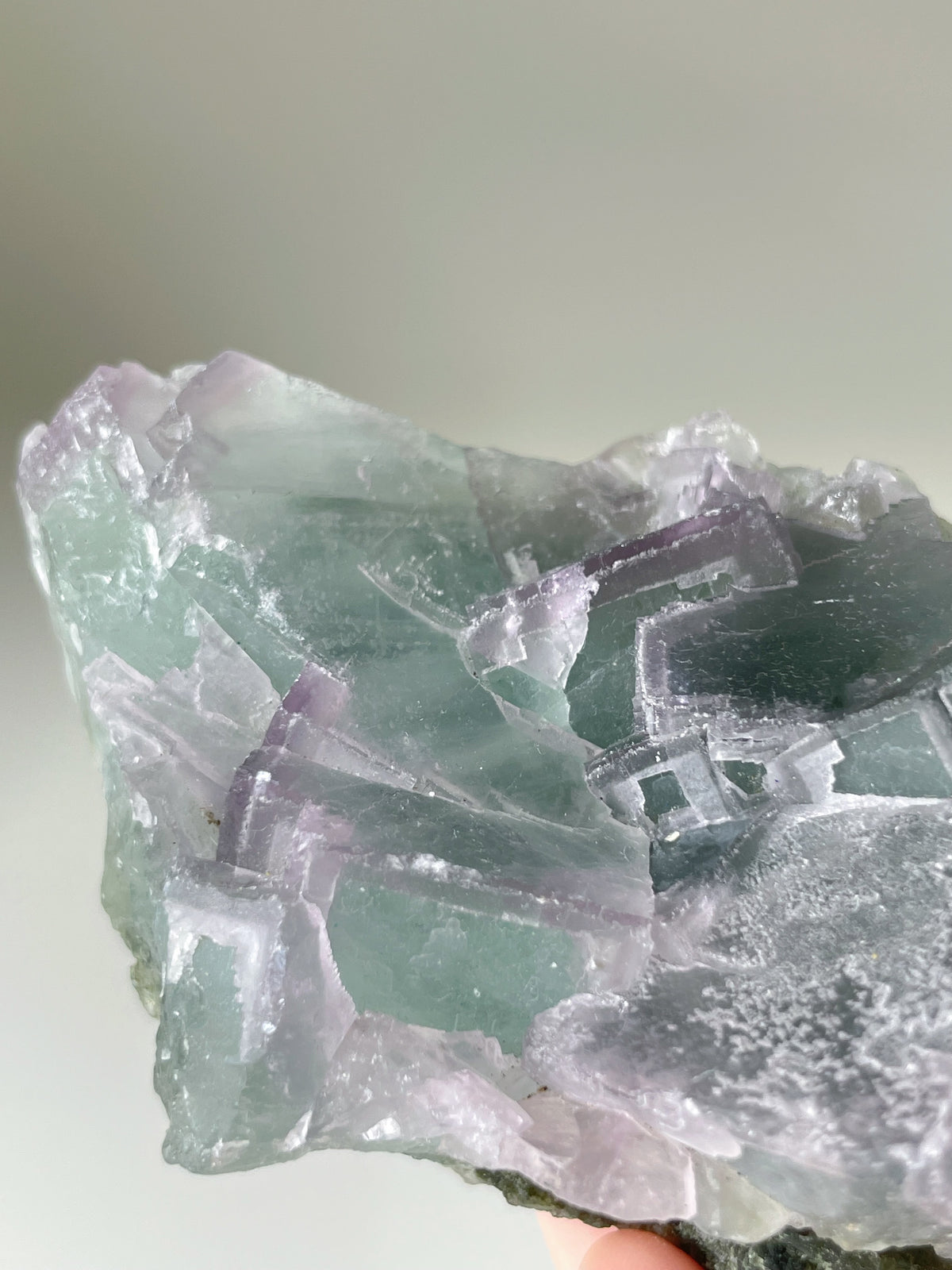 Beautiful fluorite crystal specimen showcasing vibrant green and purple hues, with intricate formations.