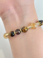 Elegant bracelet featuring 8.5mm Tiger's Eye and Golden Healer beads, accented with gold spacers.