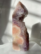 Stunning pink and purple amethyst crystal tower with natural formations and a glossy finish.