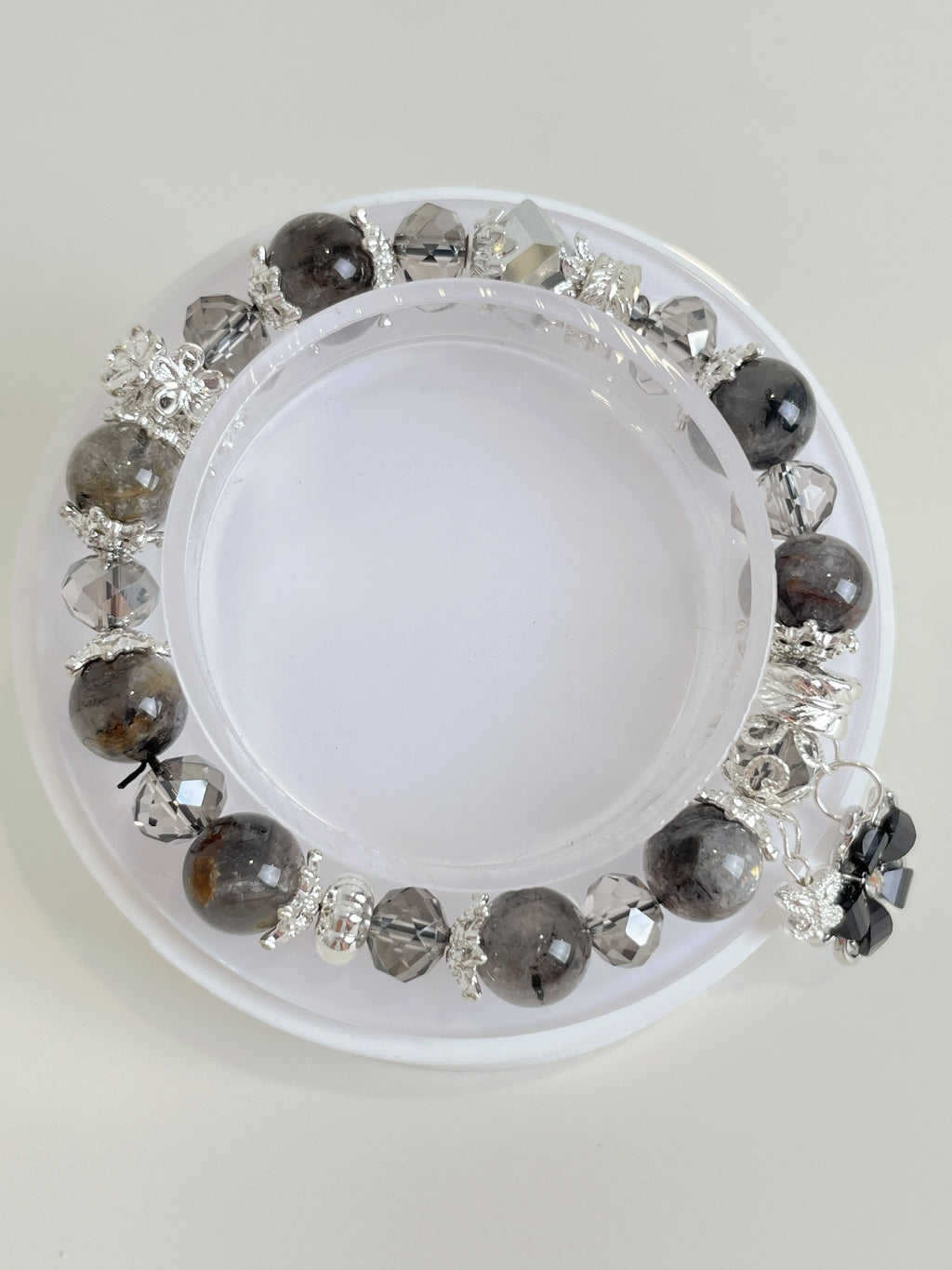 Beautiful quartz bracelet featuring 9.5mm beads with silver accents, displayed on a white background.