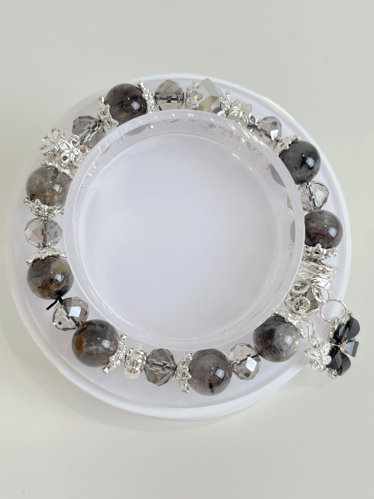 Beautiful quartz bracelet featuring 9.5mm beads with silver accents, displayed on a white background.