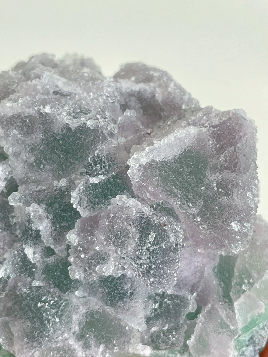 Beautiful crystal specimen of sugar fluorite with a mix of purple and green hues, showcasing its natural texture.