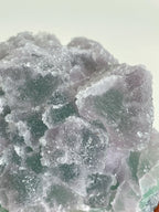 Beautiful crystal specimen of sugar fluorite with a mix of purple and green hues, showcasing its natural texture.