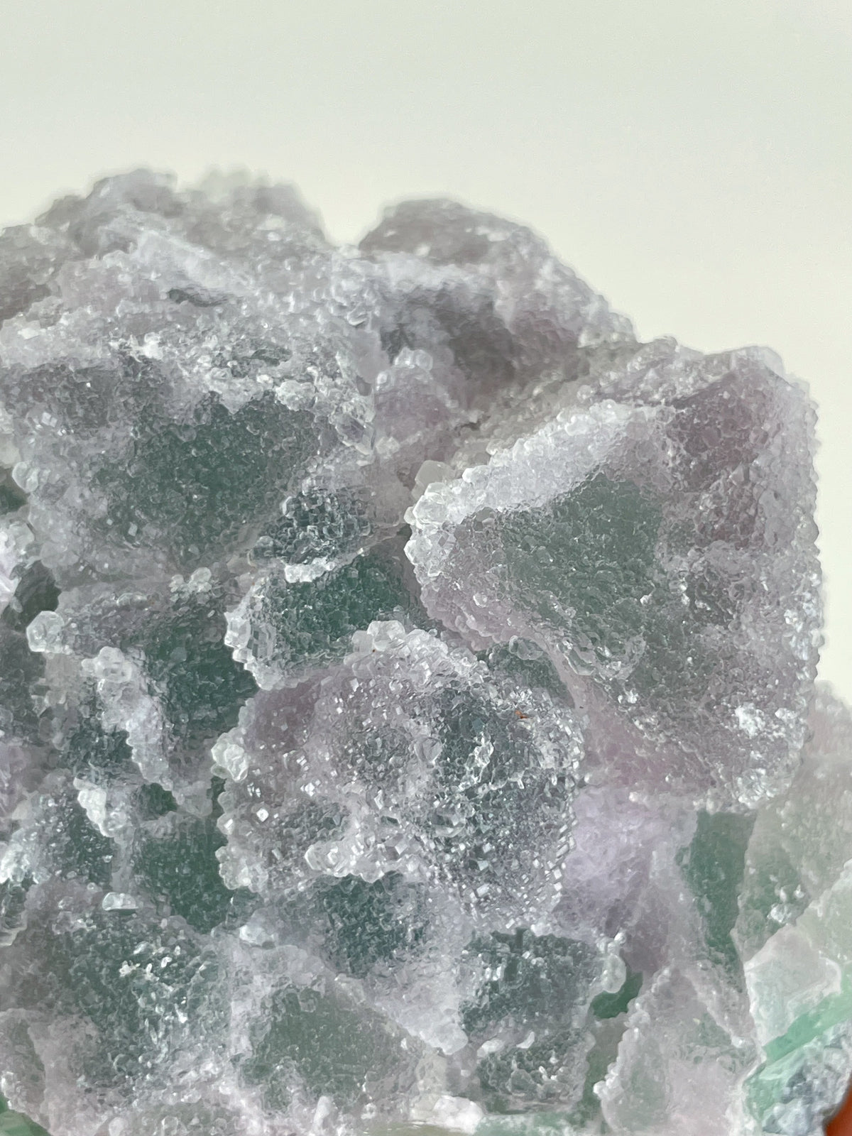 Beautiful crystal specimen of sugar fluorite with a mix of purple and green hues, showcasing its natural texture.