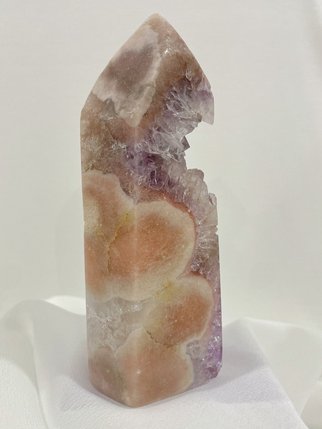 Beautiful pink and purple amethyst crystal tower with unique floral patterns, showcasing natural textures.