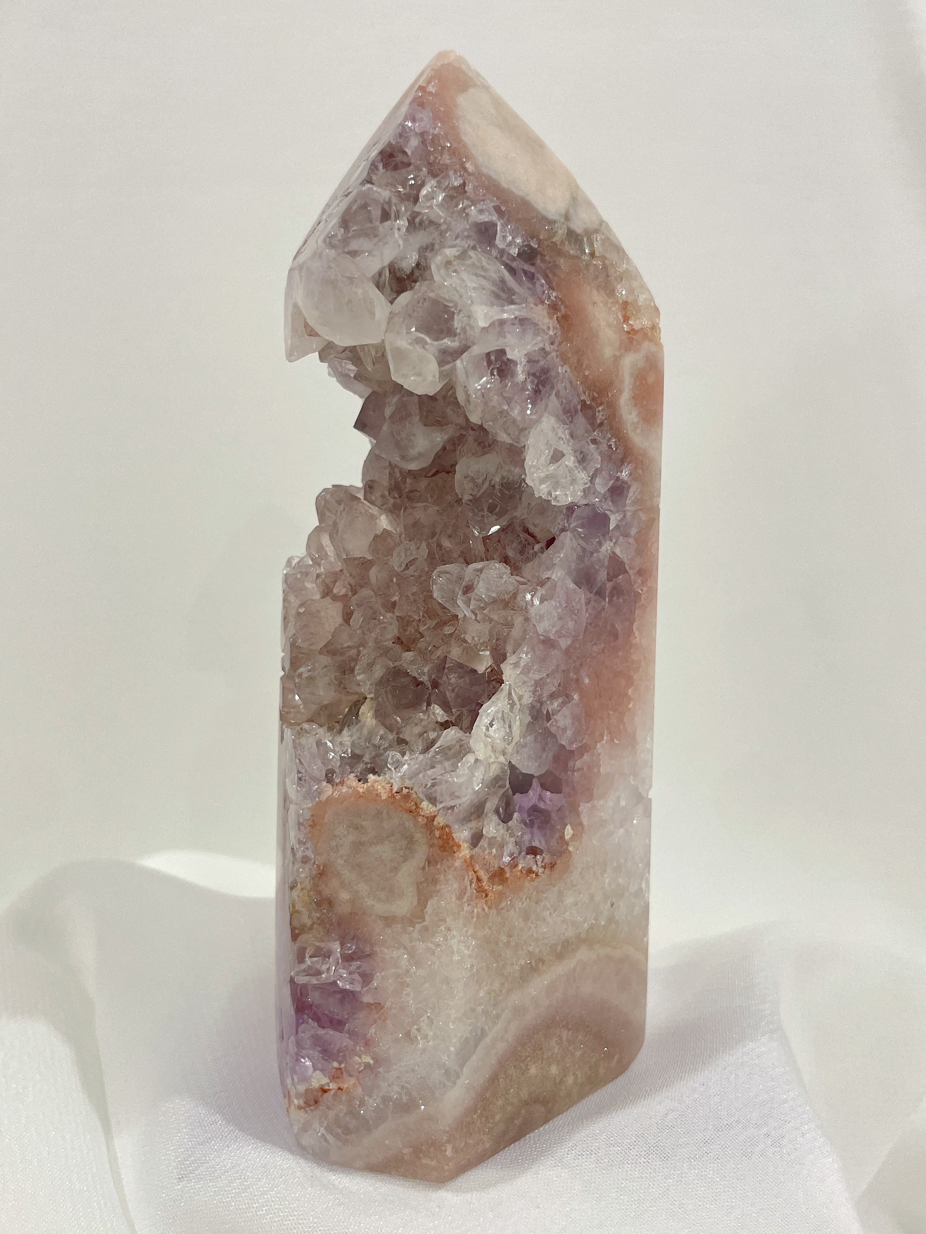Stunning purple and pink amethyst tower with sparkling crystal formations, showcasing natural beauty and elegance.