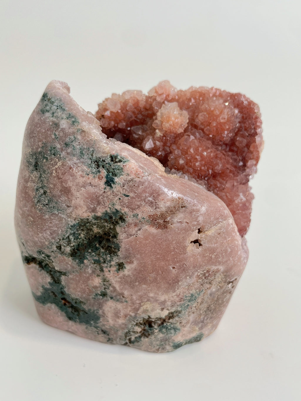 Beautiful pink amethyst freeform specimen with a textured surface and hints of green mineral accents.