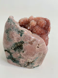Beautiful pink amethyst freeform specimen with a textured surface and hints of green mineral accents.