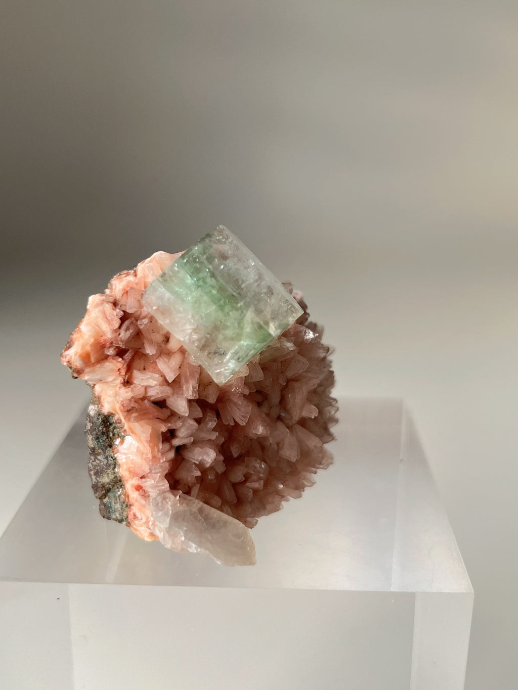 Beautiful pink Heulandite and Apophyllite crystal specimen on a clear display stand.
