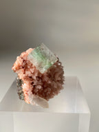 Beautiful pink Heulandite and Apophyllite crystal specimen on a clear display stand.