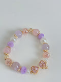 Beautiful bracelet featuring pink amethyst and rose quartz beads, accented with gold and pearl details.