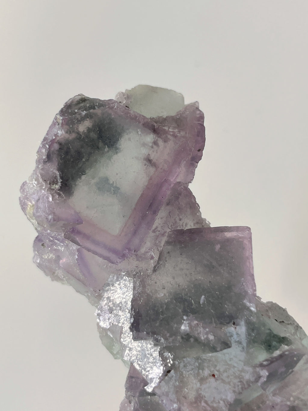 Beautiful crystal specimen featuring translucent purple fluorite with layered textures and a sparkling finish.