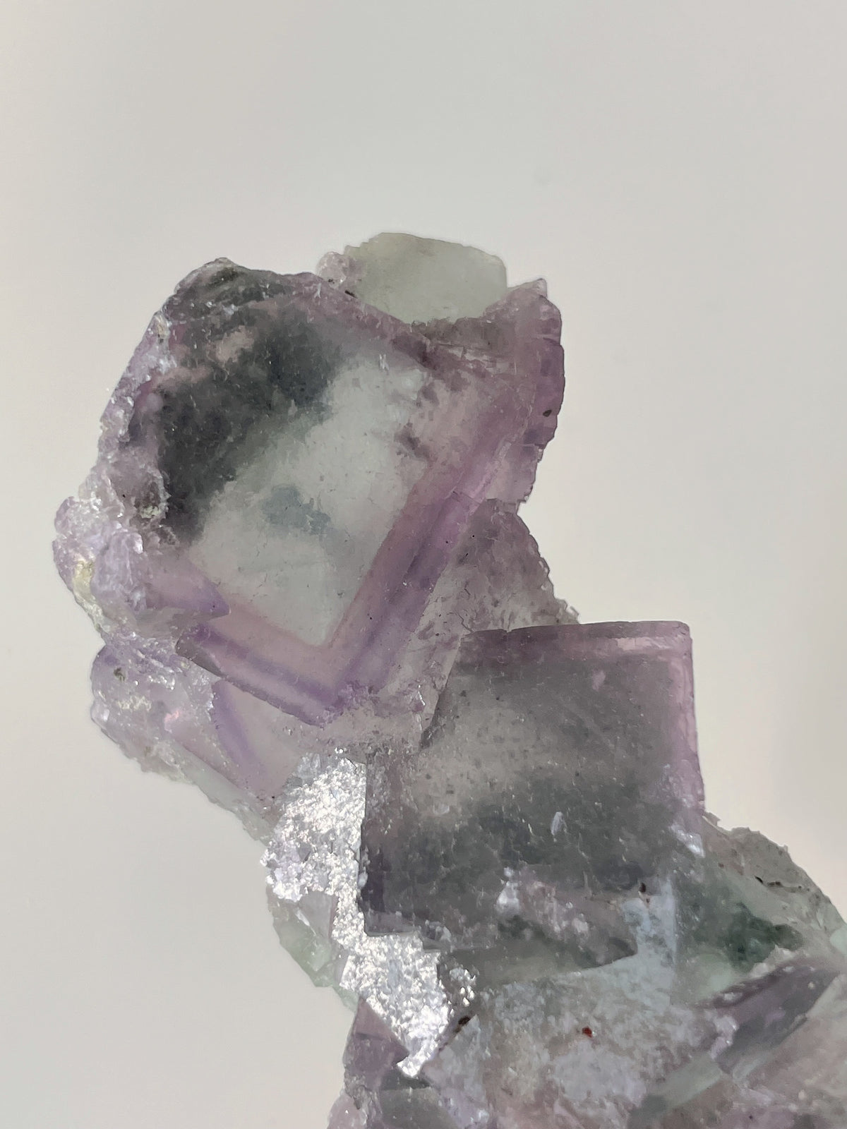Beautiful crystal specimen featuring translucent purple fluorite with layered textures and a sparkling finish.