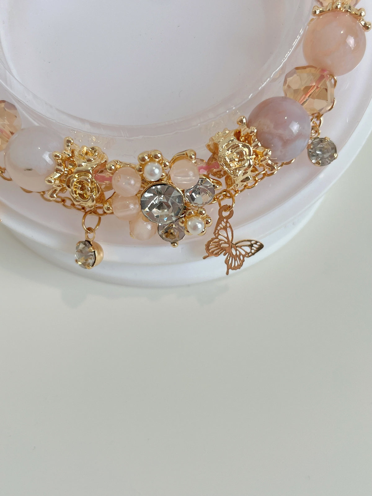 Beautiful flower agate butterfly bracelet featuring pink and gold accents, adorned with sparkling crystals.