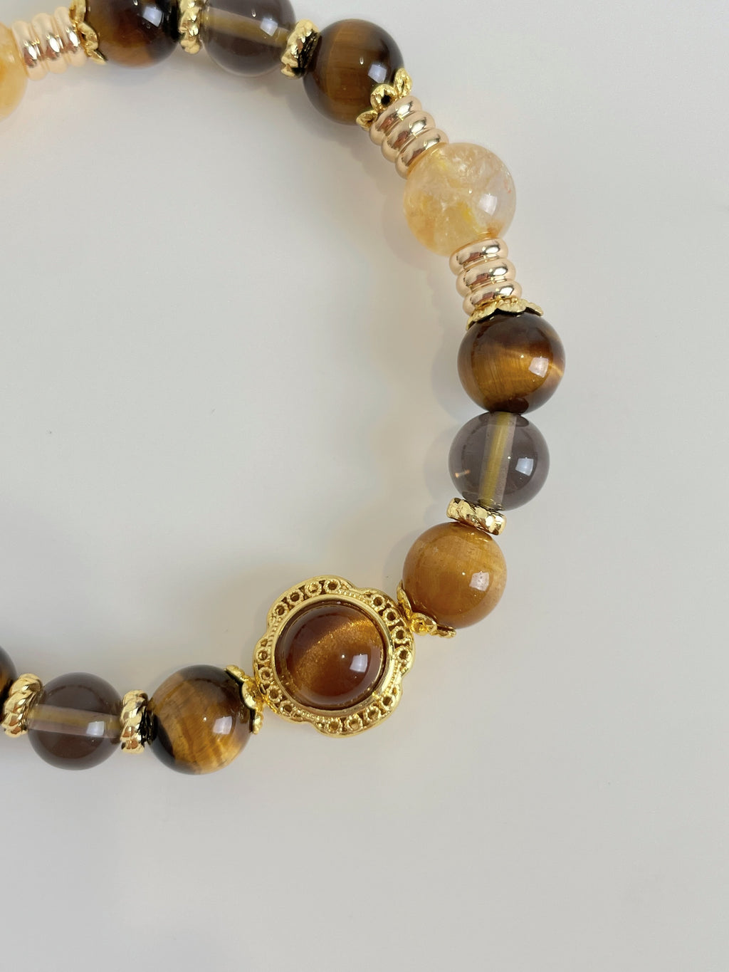 Beautiful bracelet featuring 8.5mm Tiger's Eye and Golden Healer beads, accented with gold details.