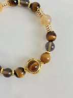 Beautiful bracelet featuring 8.5mm Tiger's Eye and Golden Healer beads, accented with gold details.