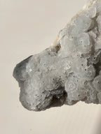 Beautiful crystal specimen featuring light gray calcite with pyrite accents on quartz, showcasing natural textures.