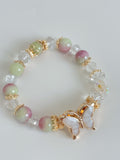 Beautiful bracelet featuring 10mm watermelon chalcedony beads, clear crystals, and a butterfly charm.