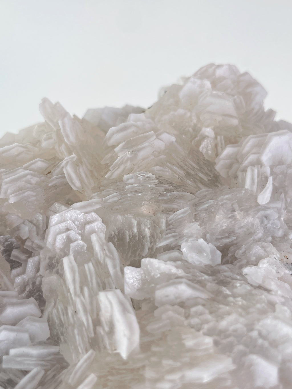 Beautiful biscuit calcite crystal specimen with layered, translucent formations, showcasing natural textures.