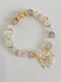 Beautiful flower agate bracelet featuring pink and clear crystal beads, adorned with a delicate butterfly charm.