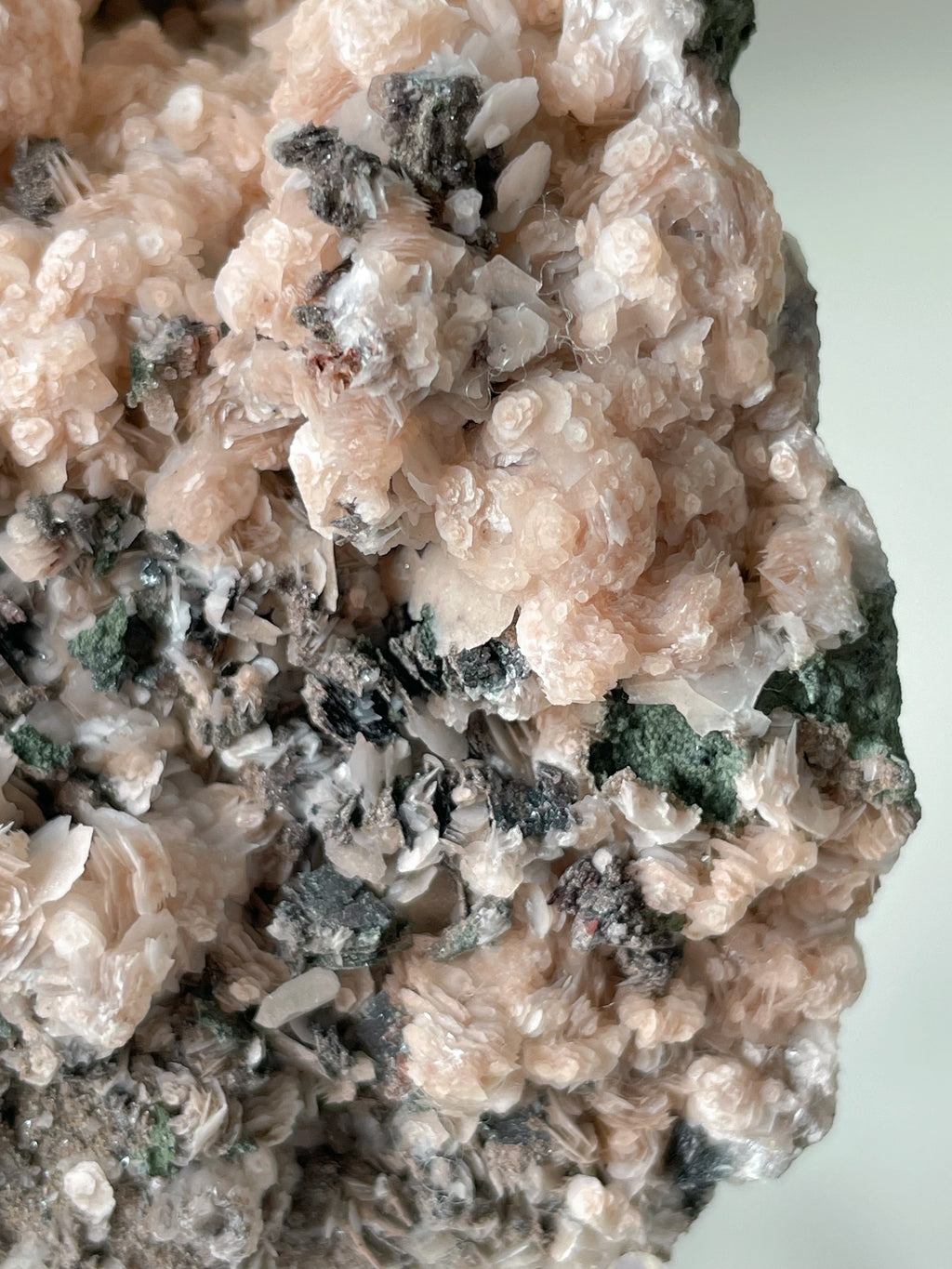 Beautiful pink calcite specimen with intricate quartz and arsenopyrite details, showcasing natural textures.