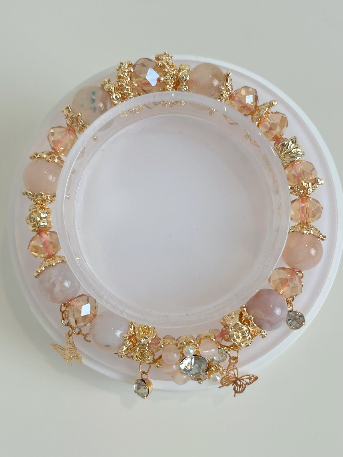 Beautiful flower agate butterfly bracelet featuring pink and gold accents, adorned with sparkling crystals.