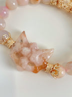 Beautiful flower agate fox charm bracelet with 9mm beads and gold accents, showcasing soft pink hues.