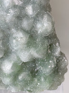 Beautiful green fluorite specimen with sparkling crystal formations, showcasing natural textures and colors.
