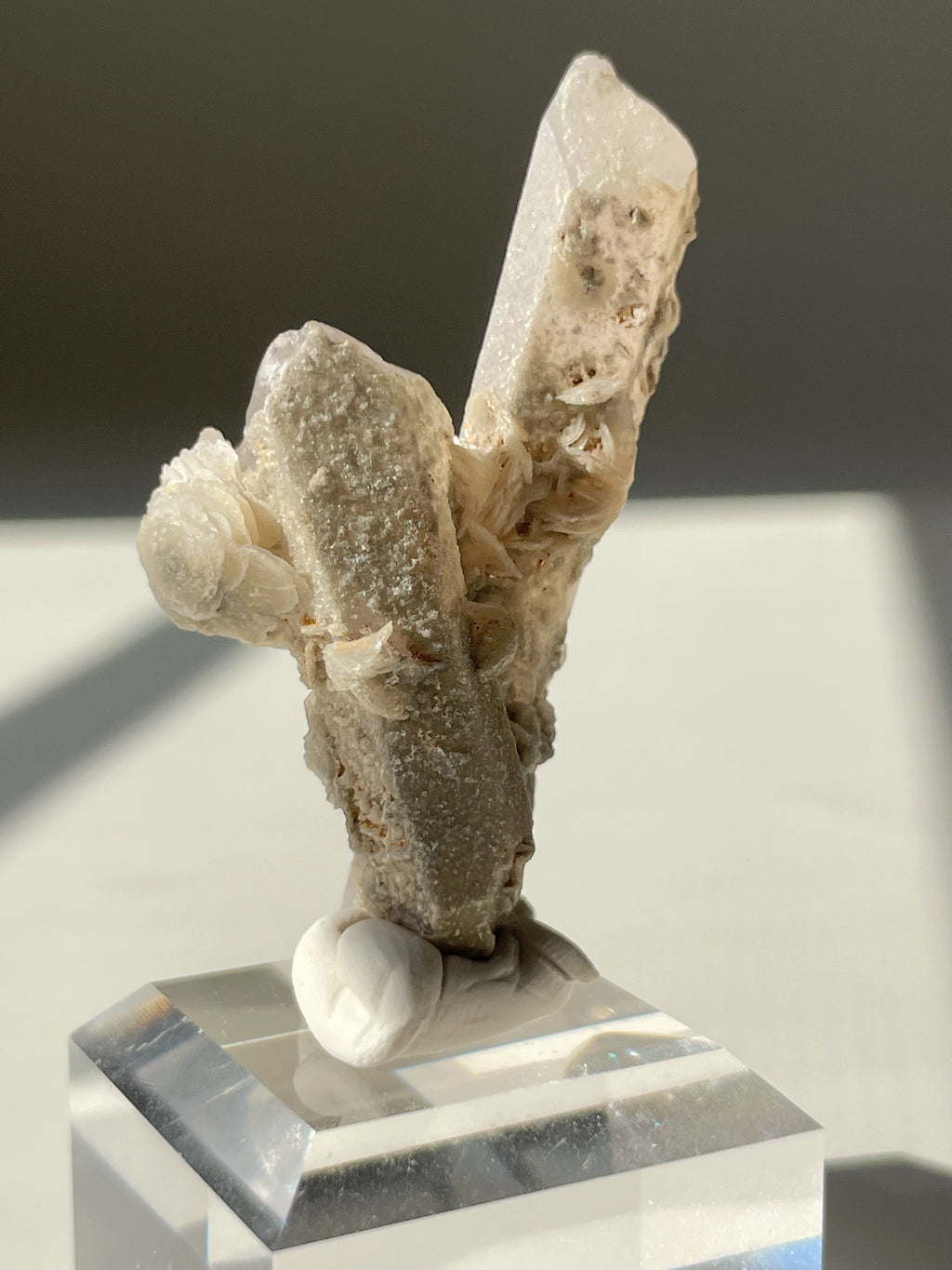 Beautiful flower calcite crystal specimen on a clear display base, showcasing unique textures and formations.