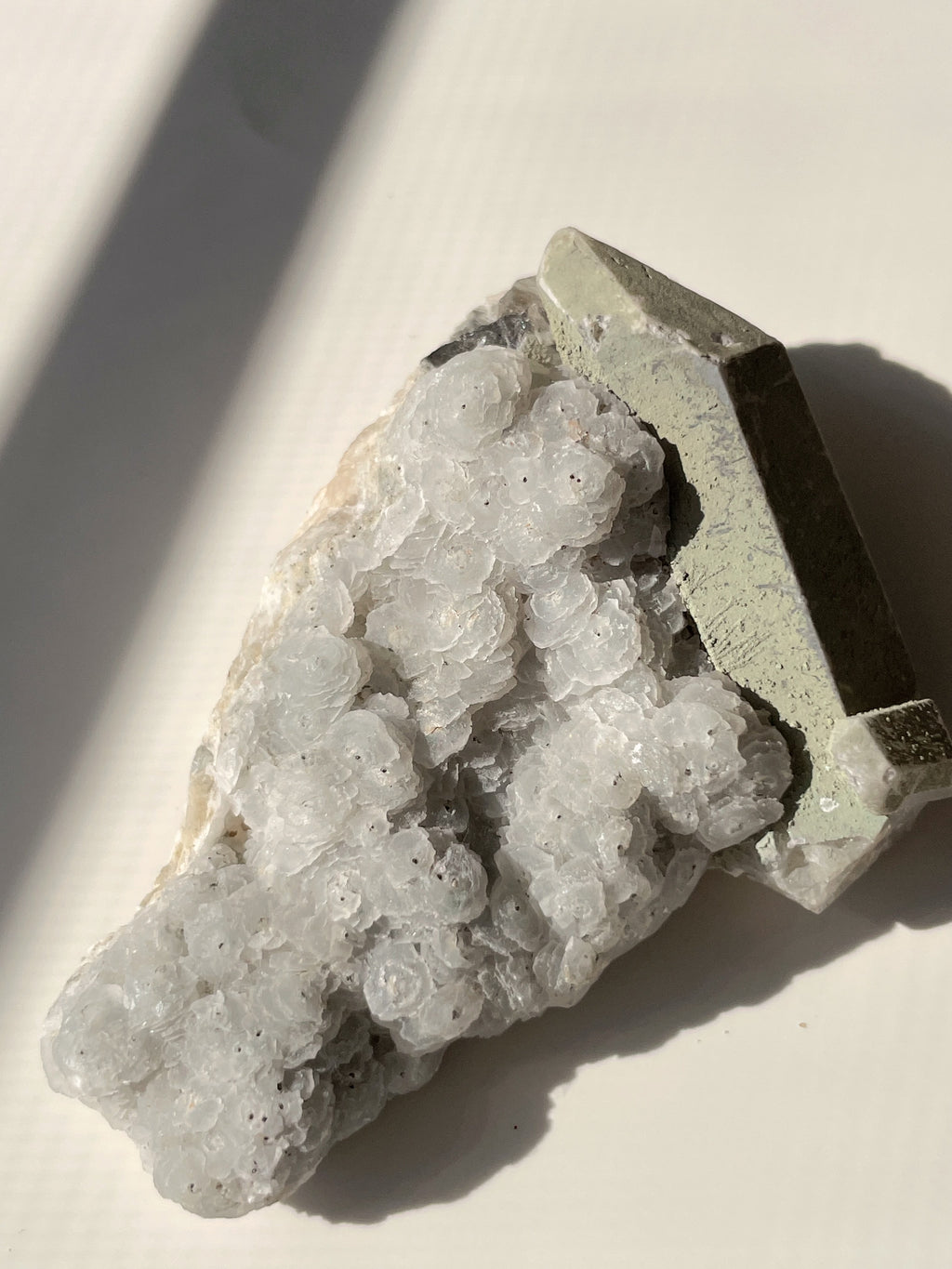 Beautiful crystal specimen featuring delicate white calcite with pyrite accents on quartz, showcasing natural textures.