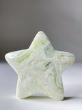 Green Maligano Jasper star shaped crystal specimen with intricate patterns and a smooth surface.