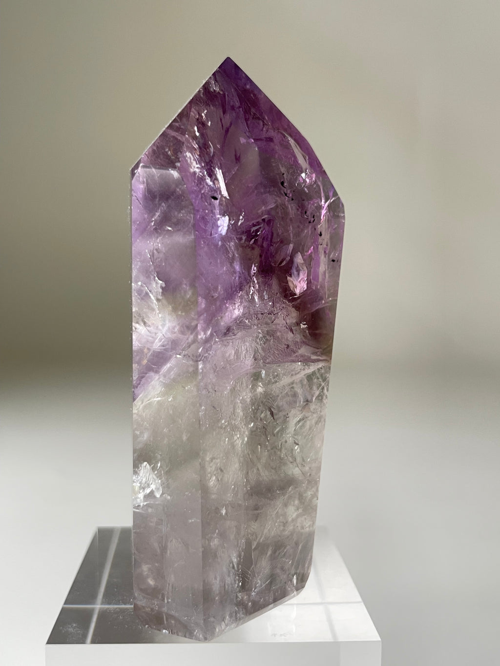 Beautiful Brazilian Phantom Amethyst tower with a stunning purple hue and clear facets, showcasing natural crystal
