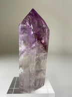 Beautiful Brazilian Phantom Amethyst tower with a stunning purple hue and clear facets, showcasing natural crystal