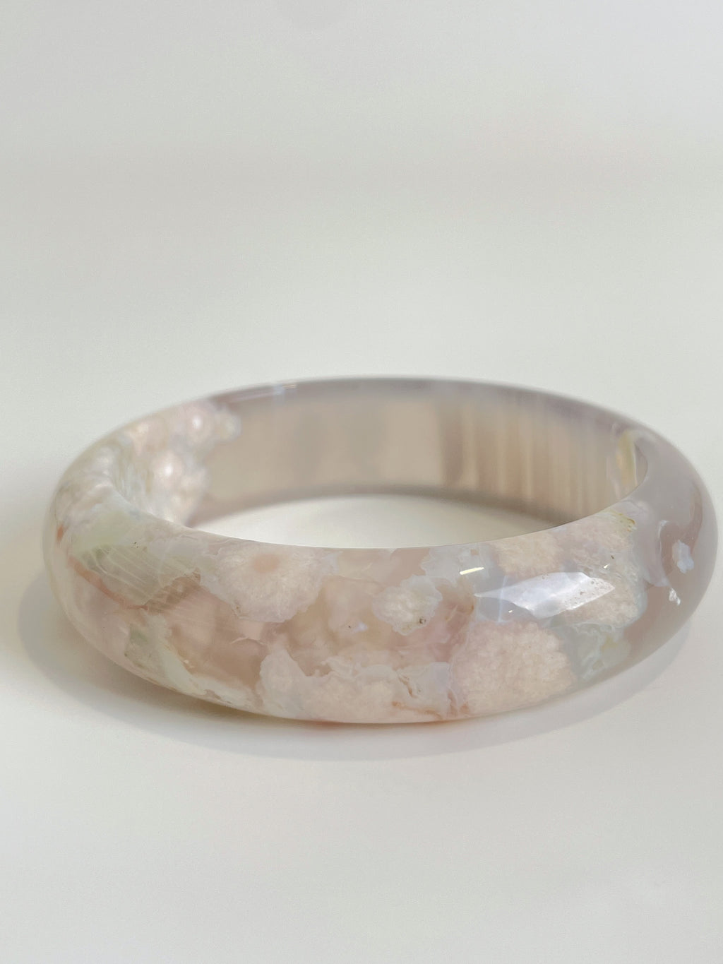 Beautiful flower agate bangle showcasing soft pink hues and intricate patterns, perfect for stylish accessorizing.