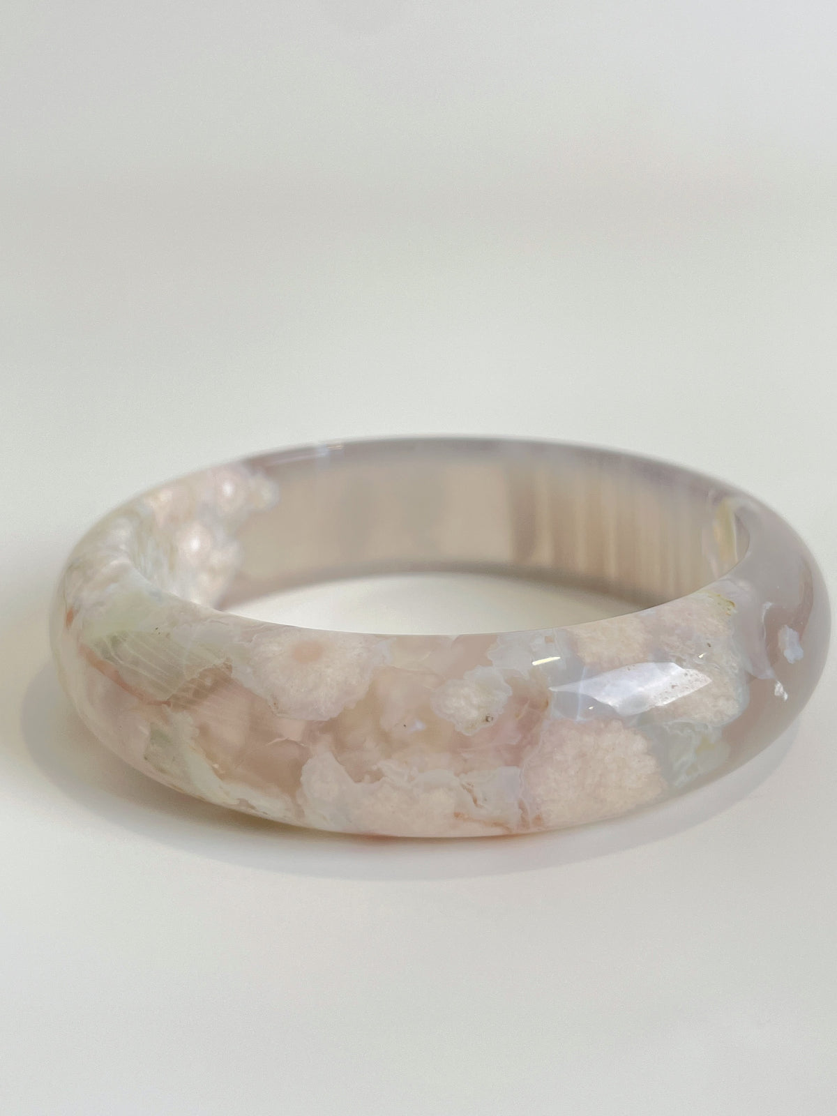 Beautiful flower agate bangle showcasing soft pink hues and intricate patterns, perfect for stylish accessorizing.