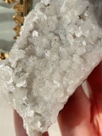 Close-up of a stunning quartz specimen with sparkling pyrite and calcite crystals, showcasing natural textures.