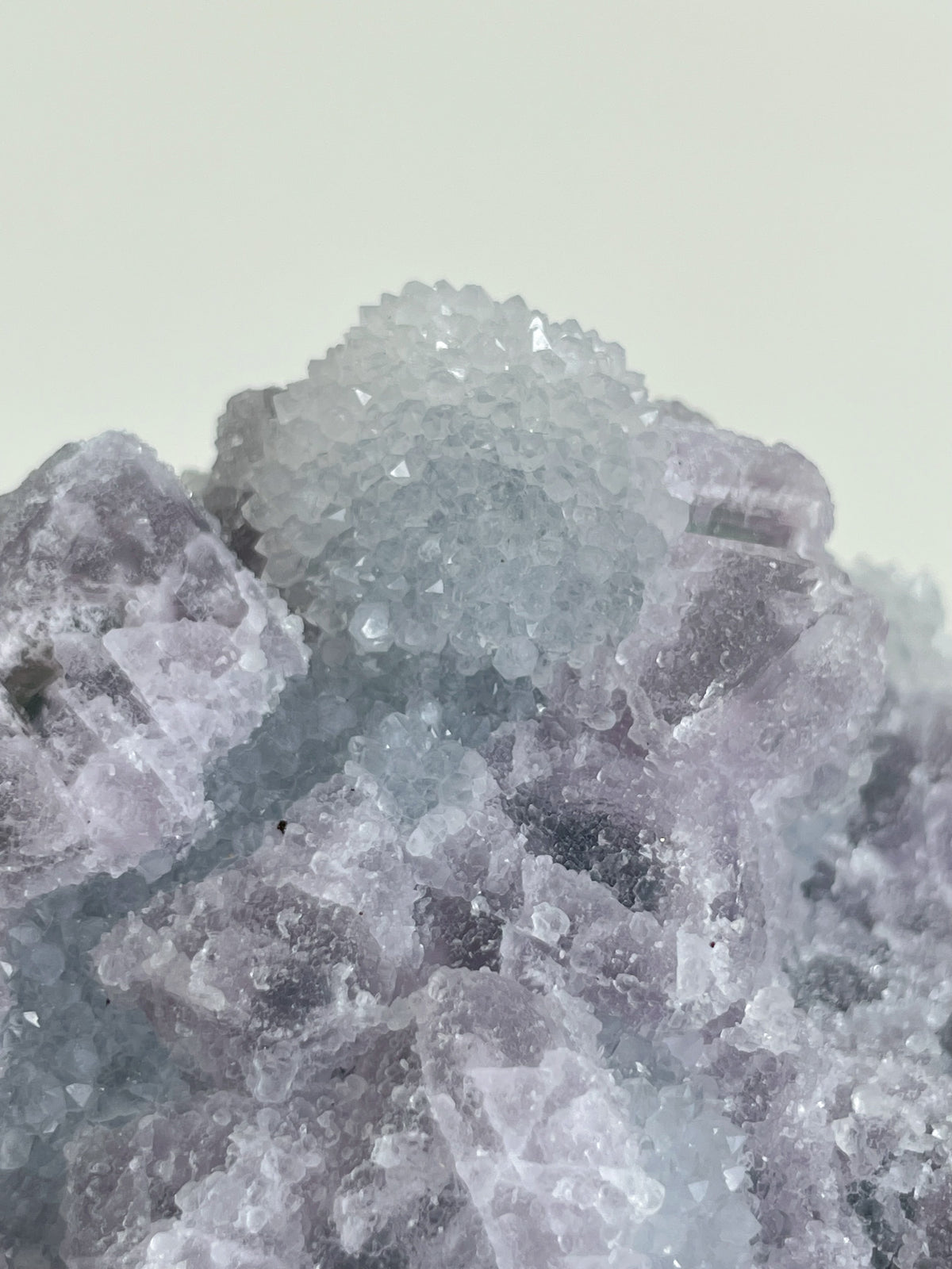Beautiful crystal specimen of 1KG Sugar Fluorite with a light purple hue and sparkling facets.