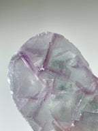 Beautiful fluorite crystal specimen with intricate geometric patterns and soft purple hues.