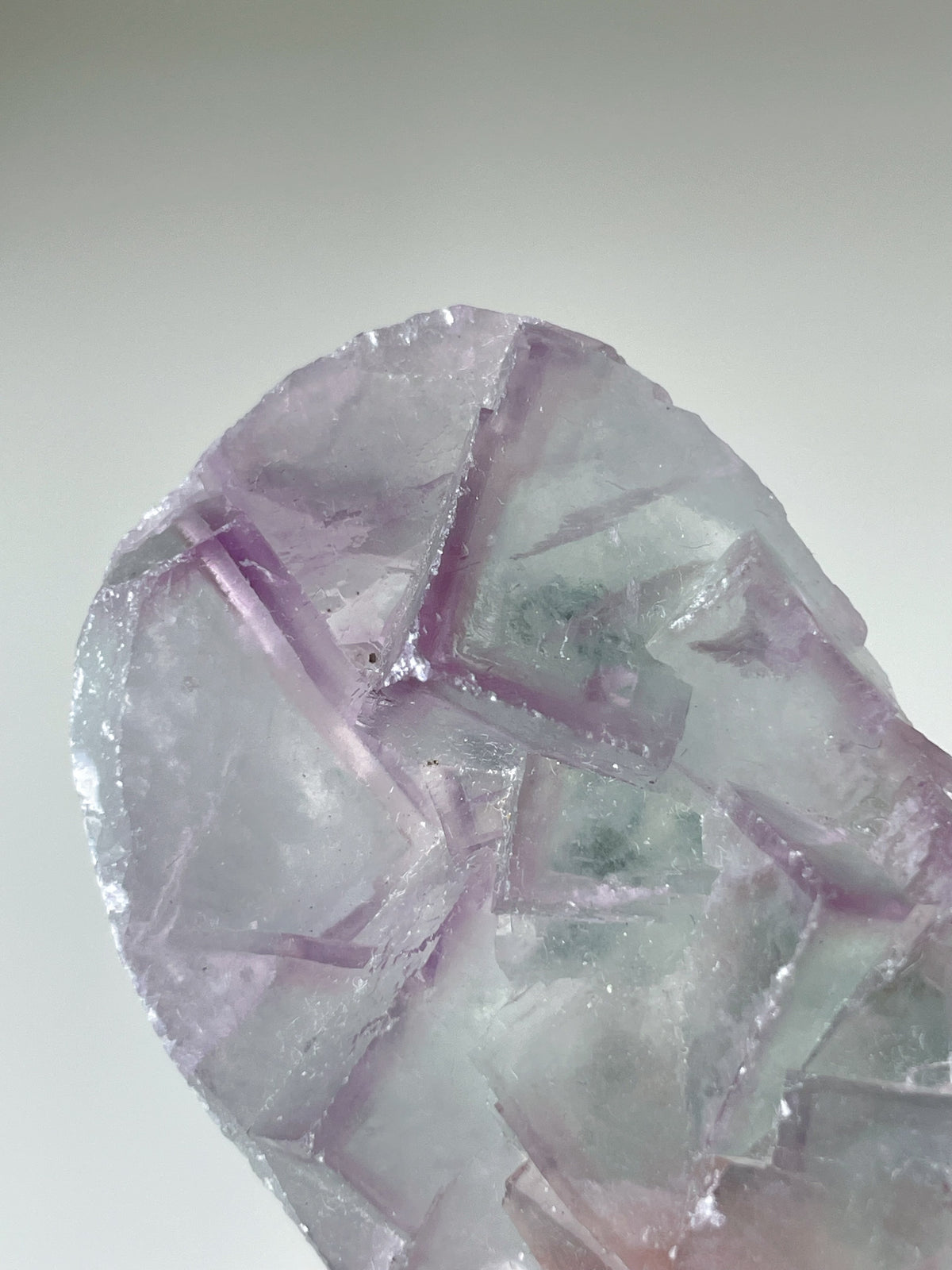 Beautiful fluorite crystal specimen with intricate geometric patterns and soft purple hues.