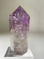 Brazilian Phantom Amethyst tower with a stunning purple hue, showcasing intricate crystal formations.