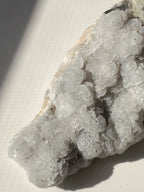 Beautiful crystal specimen featuring delicate petal calcite formations with a textured surface.