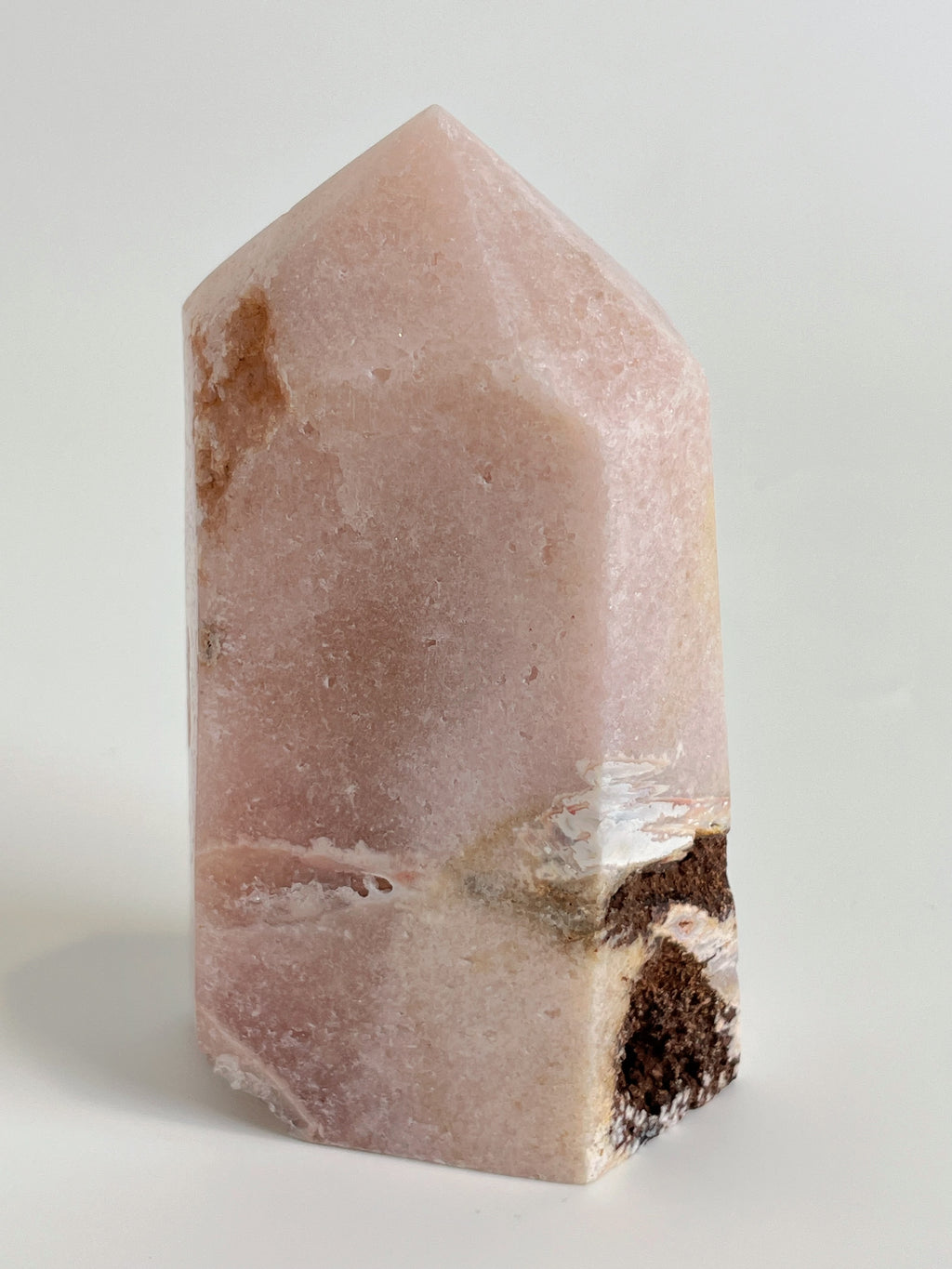 Beautiful pink amethyst tower with natural patterns and a smooth surface, showcasing its crystal structure.