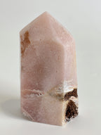 Beautiful pink amethyst tower with natural patterns and a smooth surface, showcasing its crystal structure.