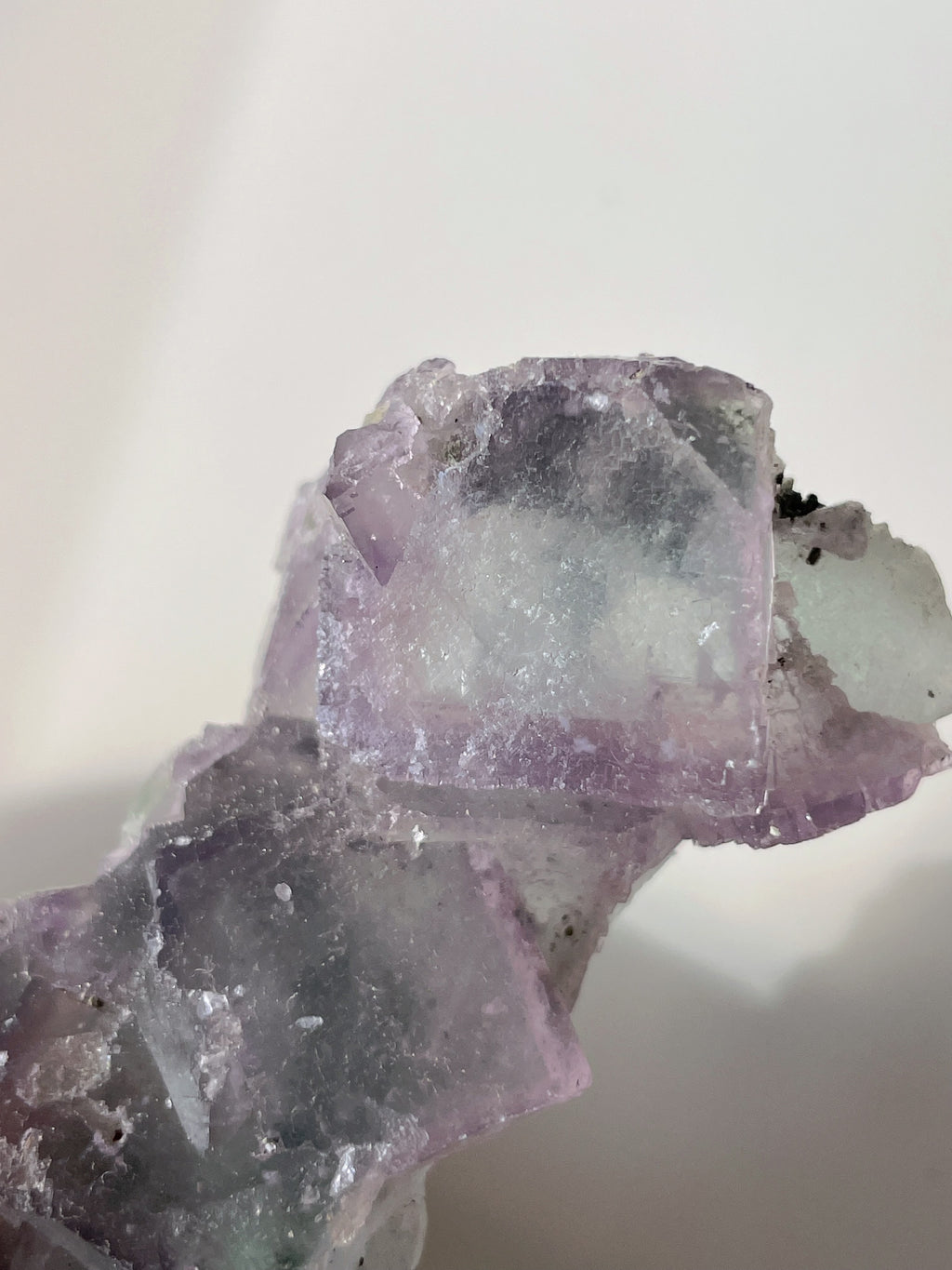Beautiful crystal specimens featuring translucent purple fluorite with natural edges and textures.