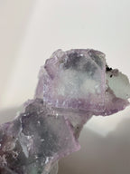 Beautiful crystal specimens featuring translucent purple fluorite with natural edges and textures.