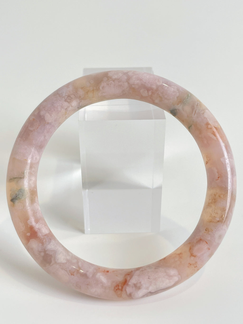 Beautiful flower agate bangle in soft pink hues, showcasing unique patterns and textures.
