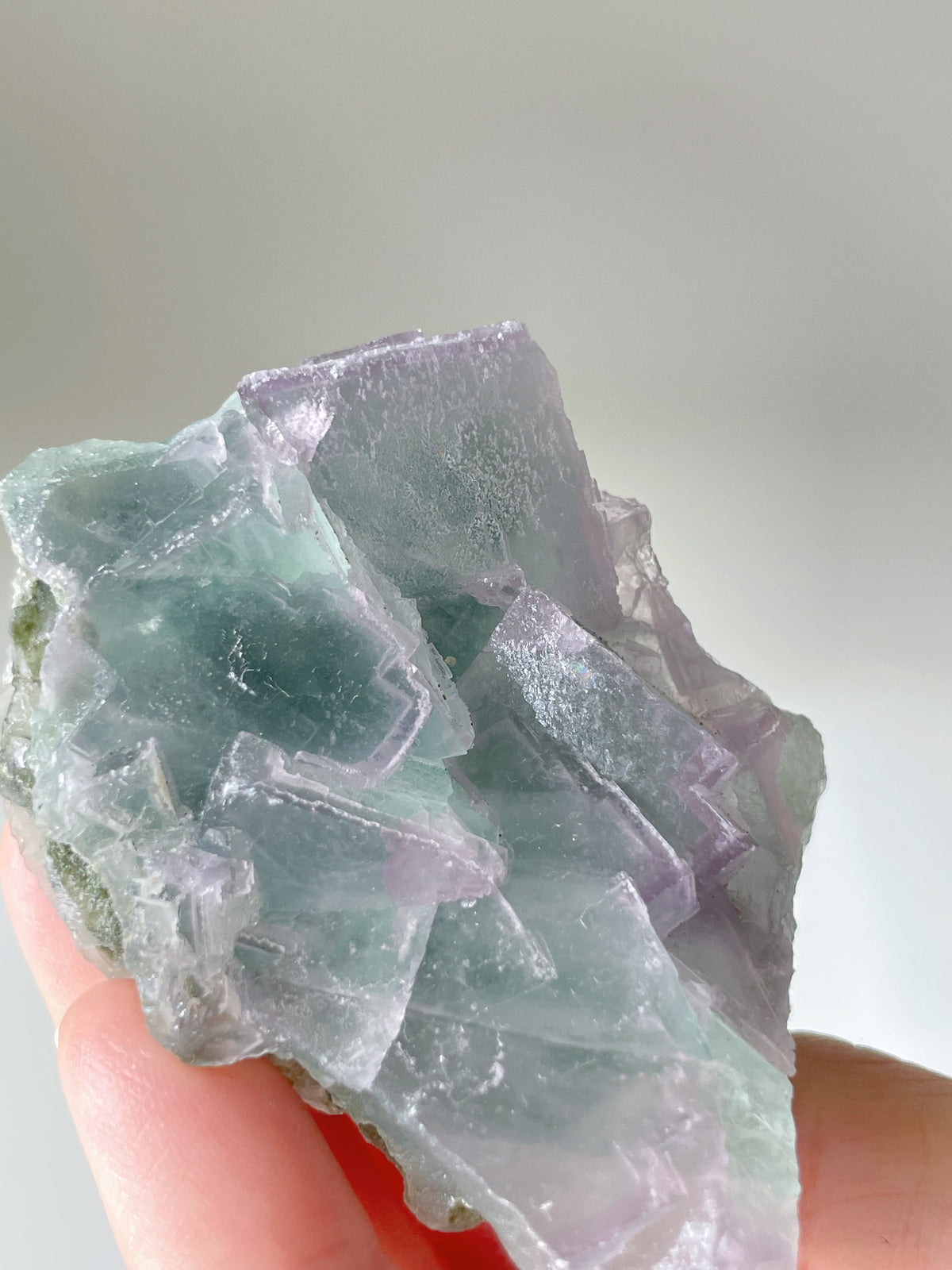 Beautiful fluorite crystal specimen with shades of green and purple, showcasing natural formations and clarity.