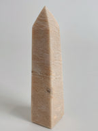 Peach Scolecite tower with a smooth, polished surface, showcasing its natural beauty and unique shape.