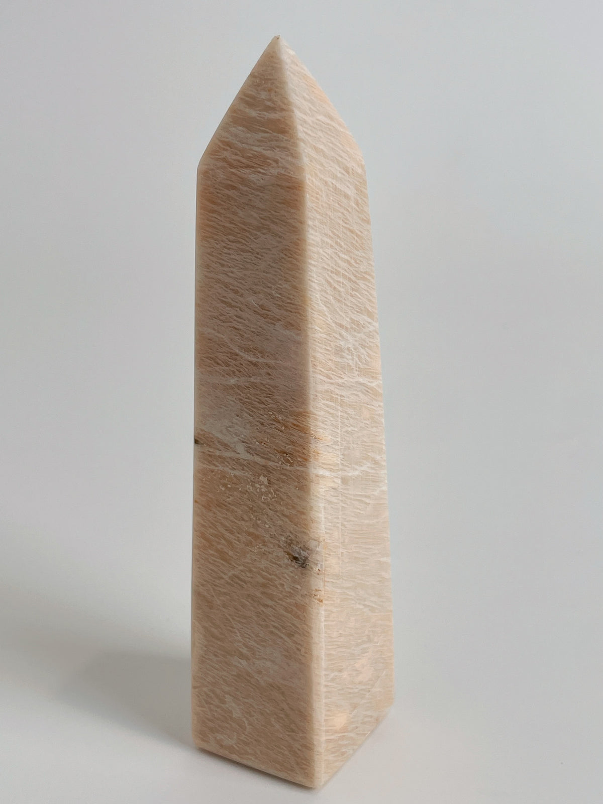 Peach Scolecite tower with a smooth, polished surface, showcasing its natural beauty and unique shape.